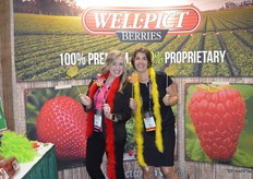 Johnna Johnson with Marketing Plus and Marieke Hemmes with FreshPlaza are having fun with the Mardi Gras theme.